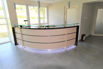 A reception desk with a curved tabletop